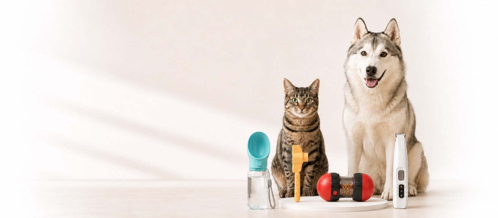Un husky y un gato junto a productos de cuidado, hidratación y juego para mascotas